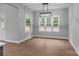 Bright dining room area illuminated by stylish light fixture and large windows with great natural light at 209 Stafford Estates Dr, Salisbury, NC 28146