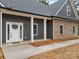 View of front entrance with white door and partial stone siding at 209 Stafford Estates Dr, Salisbury, NC 28146