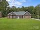 Charming single-story home featuring a well-manicured lawn and inviting stone and siding exterior at 209 Stafford Estates Dr, Salisbury, NC 28146