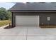 A two-car garage with an expansive concrete driveway at 209 Stafford Estates Dr, Salisbury, NC 28146