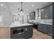 Modern kitchen with island, grey cabinets, stainless appliances and quartz countertops at 209 Stafford Estates Dr, Salisbury, NC 28146