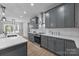 Open-concept kitchen features a large island with seating, stainless appliances, and gray cabinetry at 209 Stafford Estates Dr, Salisbury, NC 28146
