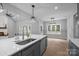 Modern kitchen features gray cabinets, stainless steel appliances, and a breakfast bar at 209 Stafford Estates Dr, Salisbury, NC 28146