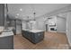 Open kitchen and living space features gray cabinets, a large island, and a fireplace at 209 Stafford Estates Dr, Salisbury, NC 28146