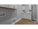 Functional laundry area with white cabinetry, offering a clean and efficient space for household chores at 209 Stafford Estates Dr, Salisbury, NC 28146