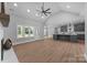 Open-concept living space with wood floors, a vaulted ceiling, and a modern kitchen at 209 Stafford Estates Dr, Salisbury, NC 28146