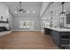 Open concept living room featuring fireplace, modern fan and island with hanging lights at 209 Stafford Estates Dr, Salisbury, NC 28146