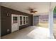 A serene patio with a ceiling fan, illuminated by natural light streaming through large windows and a glass door at 209 Stafford Estates Dr, Salisbury, NC 28146