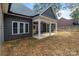 This backyard features a covered patio, providing a comfortable outdoor space with ample natural light at 209 Stafford Estates Dr, Salisbury, NC 28146
