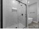 Luxurious walk-in shower adorned with decorative tile, complemented by modern fixtures for a spa-like feel at 209 Stafford Estates Dr, Salisbury, NC 28146