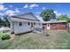 Exterior view of house with a ramp, grassy yard, and detached brick garage at 220 Parker Ave, Mooresville, NC 28115