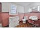 Vintage bathroom featuring pink tiling, classic fixtures, and retro charm at 220 Parker Ave, Mooresville, NC 28115