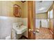 Utility room with vintage sink, mirror, and access to laundry area at 220 Parker Ave, Mooresville, NC 28115
