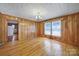 Classic living room with wood paneling, hardwood floors, and natural light at 220 Parker Ave, Mooresville, NC 28115