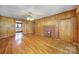 Cozy living room with hardwood floors, a brick fireplace, and convenient access to the adjacent kitchen at 220 Parker Ave, Mooresville, NC 28115