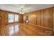 Spacious living room featuring beautiful hardwood floors, natural light, and a vintage ceiling fan at 220 Parker Ave, Mooresville, NC 28115