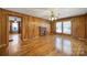 Inviting living room with hardwood floors, a charming brick fireplace, and ample natural light at 220 Parker Ave, Mooresville, NC 28115