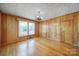 Bright living area features wood-paneled walls, hardwood floors, and ample sunlight at 220 Parker Ave, Mooresville, NC 28115