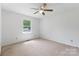 Bedroom with neutral carpet, ceiling fan, and a view of the front yard at 2223 Pacer Rd, Lancaster, SC 29720