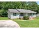 A charming single-story home with a cozy front porch and lovely green shutters at 2223 Pacer Rd, Lancaster, SC 29720
