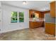 Bright kitchen with views to the outside, features ample cabinet space and tile floor at 2223 Pacer Rd, Lancaster, SC 29720