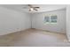 Bright living room with neutral carpet, ceiling fan, and a large window at 2223 Pacer Rd, Lancaster, SC 29720