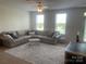 Inviting living room with plush sectional sofa, area rug, and ample natural light at 2411 Bonterra Blvd, Indian Trail, NC 28079
