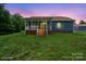 Inviting backyard featuring a covered porch, spacious yard, and well-maintained blue siding house at 2949 Anderson Burgess Rd, Sharon, SC 29742