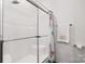 All-white bathroom offering a sliding glass shower door and a floral shower curtain at 2949 Anderson Burgess Rd, Sharon, SC 29742