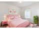 Bedroom in all shades of pink with floral wall art and a large monstera plant at 2949 Anderson Burgess Rd, Sharon, SC 29742