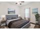 Staged bedroom features a gray bed, two side tables, neutral toned walls, and wood floor at 2949 Anderson Burgess Rd, Sharon, SC 29742