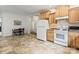 Kitchen and dining area with white appliances, wood cabinets, and tile flooring at 2949 Anderson Burgess Rd, Sharon, SC 29742
