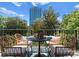 Relax on this cozy balcony with cityscape views, featuring an outdoor table and comfortable wicker chairs at 300 W Fifth St # 509, Charlotte, NC 28202