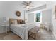 Bright bedroom featuring a queen bed, a ceiling fan, and natural light from the window at 300 W Fifth St # 509, Charlotte, NC 28202