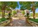 Community courtyard features lush landscaping, a beautiful fountain, and walkways to surrounding buildings at 300 W Fifth St # 509, Charlotte, NC 28202