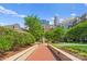 Picturesque courtyard with walking path, fountain, green space, and putting green in an urban community at 300 W Fifth St # 509, Charlotte, NC 28202