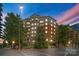 Exterior view of a beautiful building with lush trees around it and a crosswalk at 300 W Fifth St # 509, Charlotte, NC 28202