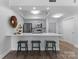 Modern kitchen features stainless appliances, breakfast bar with seating, and grey shaker cabinets at 300 W Fifth St # 509, Charlotte, NC 28202