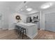 Stylish kitchen offers a breakfast bar with seating, neutral paint, and stainless appliances at 300 W Fifth St # 509, Charlotte, NC 28202