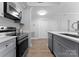 Well-lit kitchen featuring stainless steel appliances, a modern cooktop, and bright countertops at 300 W Fifth St # 509, Charlotte, NC 28202