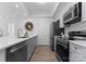Modern kitchen features stainless appliances, quartz counters, and grey shaker cabinets at 300 W Fifth St # 509, Charlotte, NC 28202