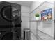 Functional laundry room with washer, dryer, and shelving at 300 W Fifth St # 509, Charlotte, NC 28202
