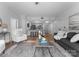 Bright living room with modern furnishings, a decorative rug, and an open view to the kitchen at 300 W Fifth St # 509, Charlotte, NC 28202