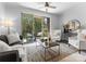 Bright living room with ceiling fan, access to a private balcony, and comfortable seating at 300 W Fifth St # 509, Charlotte, NC 28202