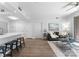 Bright and open living area showcasing a sleek kitchen island, a cozy seating arrangement, and wood flooring at 300 W Fifth St # 509, Charlotte, NC 28202