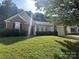 Charming single-story home featuring brick accents, a well-manicured lawn, and an attached two-car garage at 3124 Burkston Rd, Charlotte, NC 28269