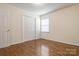Well-lit bedroom with wood floors, closet, and window at 3125 Leonard Dr, Gastonia, NC 28056