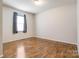 A bright bedroom with wood flooring and a window with curtains at 3125 Leonard Dr, Gastonia, NC 28056