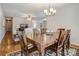 Inviting dining room with a wooden table set for six and a stylish chandelier at 3125 Leonard Dr, Gastonia, NC 28056