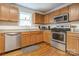 Well-lit kitchen with a stainless steel oven, microwave, and ample counter space at 3125 Leonard Dr, Gastonia, NC 28056